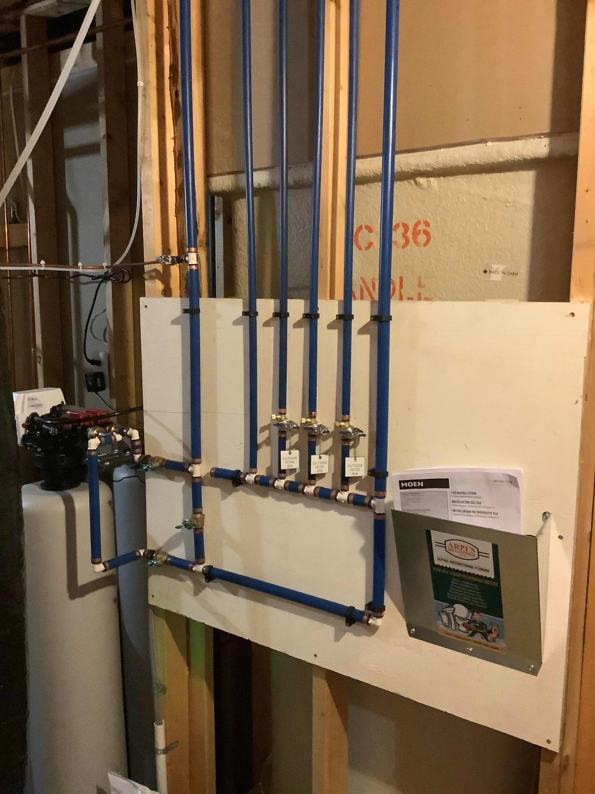 Poly-B replacement with new PEX plumbing manifold and labelled outside hose bib shut-offs installed by Arpi's in Calgary