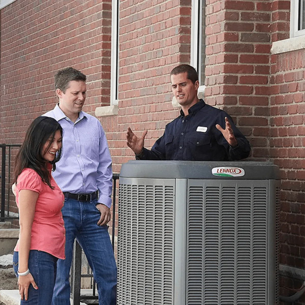 Arpi's technician explaining a Lennox air conditioner unit to homeowners outside a Calgary home