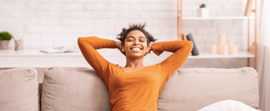 A young woman enjoys the cool comfort of her new air conditioner