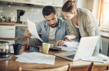 a couple looking at documents budgeting for furnace upgrades